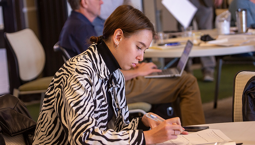 Woman taking notes during a business seminar