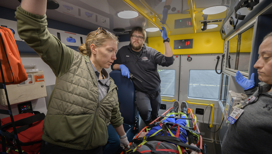 EMS students inside an ambulance transporting a patient