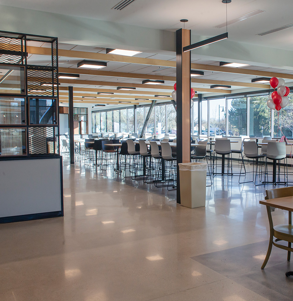 Dining area with high top tables and chairs in front of large windows