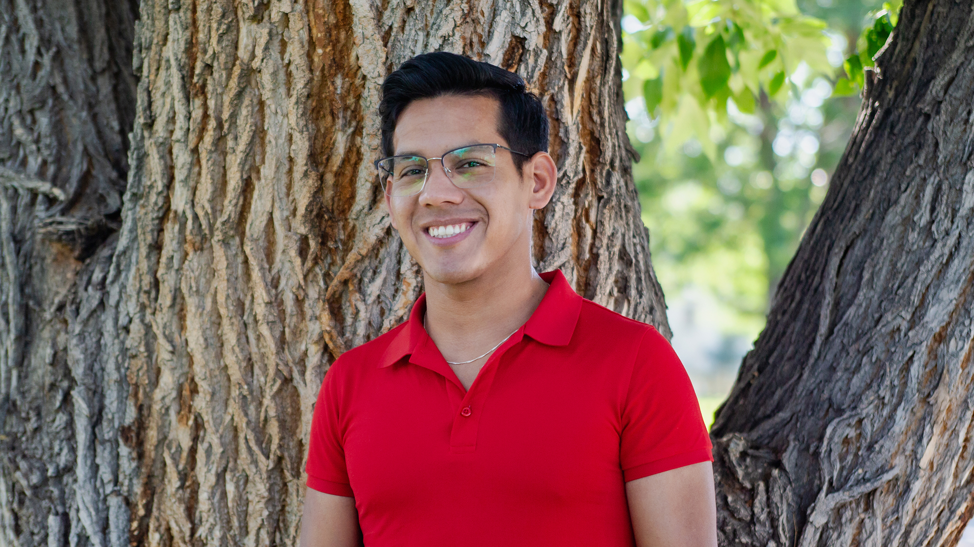 Jorge Aponte standing in front of a tree on a sunny day