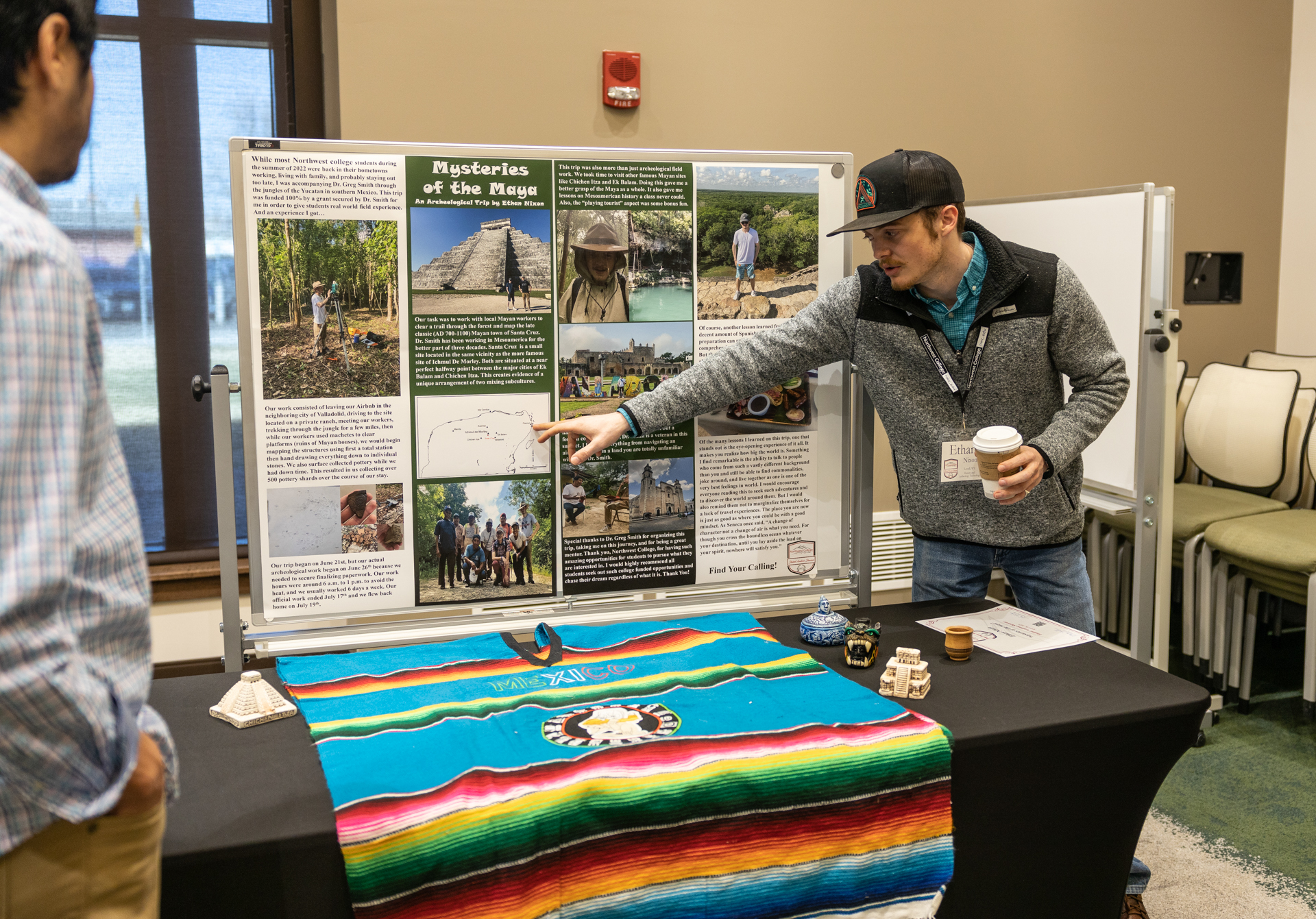 A student pointing to information on a board